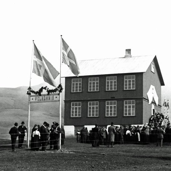 Gamli barnaskólinn á Húsavík. Myndin tekin 17.júní 1911 þegar minnst var aldarafmælis Jóns Sigurðssonar forseta. Bláhvítir fánar við hún.
